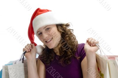 female with carry bags and santa cap