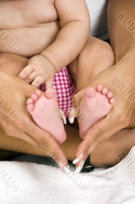 mother holding her child`s feet
