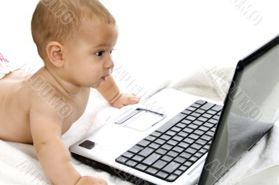 cute baby boy showing curiosity about laptop