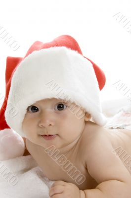 smiling toddler wearing red christmas cap