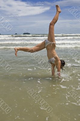 female teenager jumps on the beach
