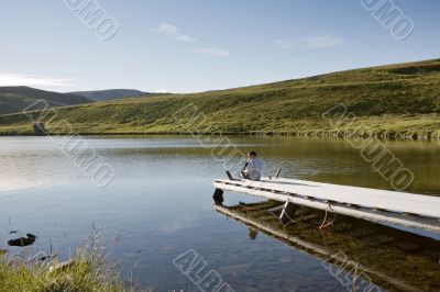 relaxing man on pier relaxing man on pier