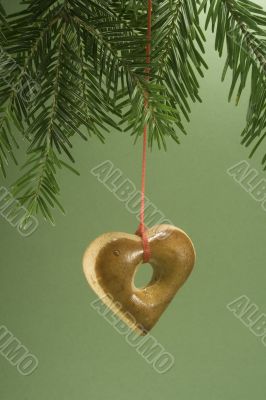 Christmas cookie hanging from fir branch