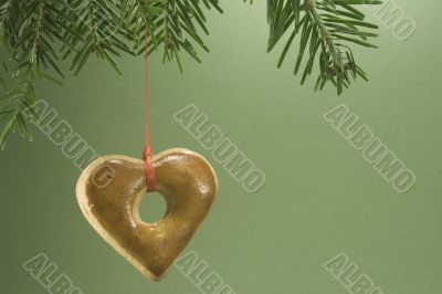 Christmas cookie hanging from fir branch