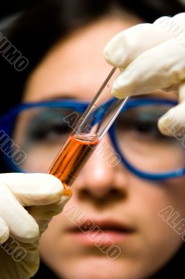 Scientist looking at test tube