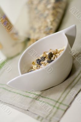 bowl full of musli and bottle of milk