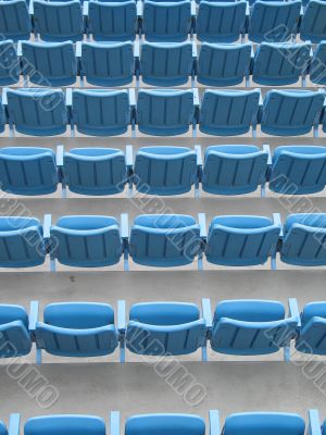 blue aligned plastic chairs