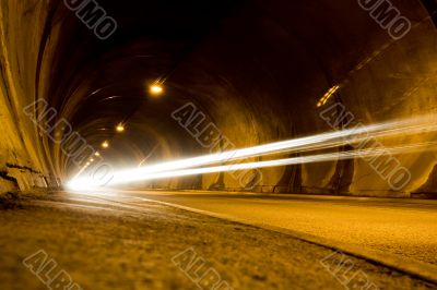 lone car moving fast in tunnel