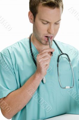 doctor putting pen in his mouth