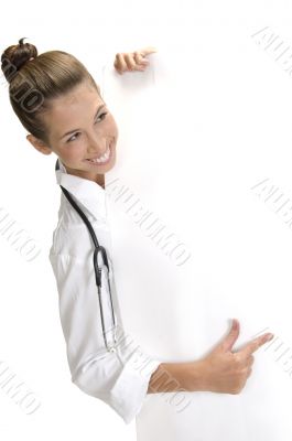 smiling lady doctor indicating to the placard