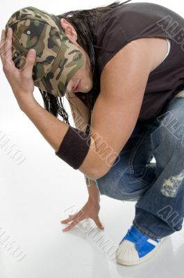 sitting young male holding cap