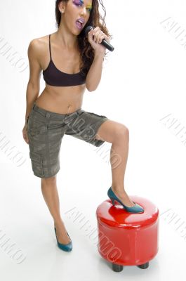 singer putting leg on stool