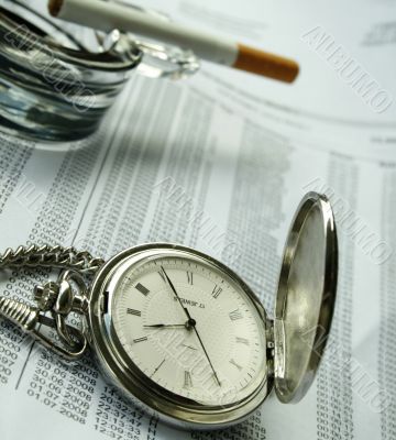 watch and  cigarette on documents
