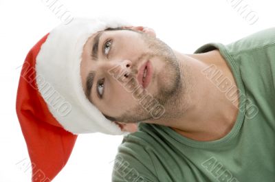 man with santa cap and looking upward