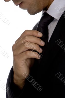 well dressed businessman adjusting his tie