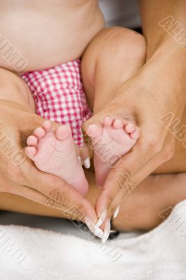 mother holding her child`s feet