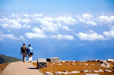 Couple going on road to blue sky in Madeira Island