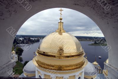 Gold domes of orthodox church with arch