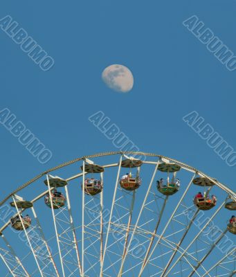 Big Ferris wheel in front of the moon Big Ferris wheel in front of the moon