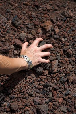 woman take volcanic stones