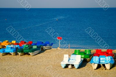 Small colorful catamarans on the beach