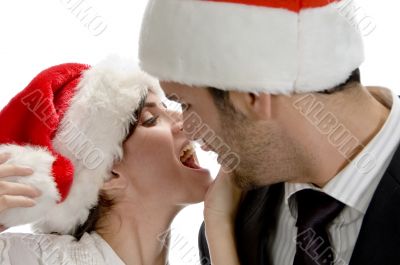 couple kissing and wearing santa cap