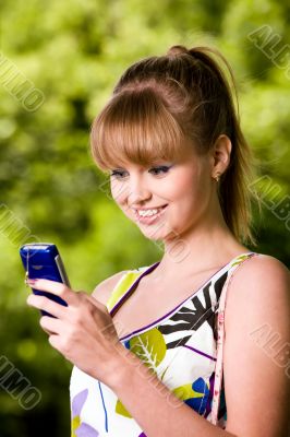 Young woman with mobile phone outdoors