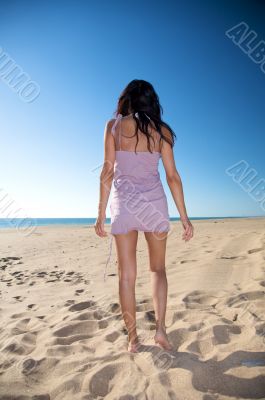 woman back walking on the sand