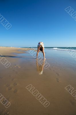 bend woman at the beach