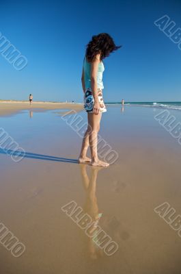 woman reflected on the sand