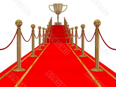 Gold cup of the winner on a red carpet path.