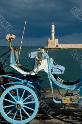 Blue traditional carriage with flowers and lighthouse