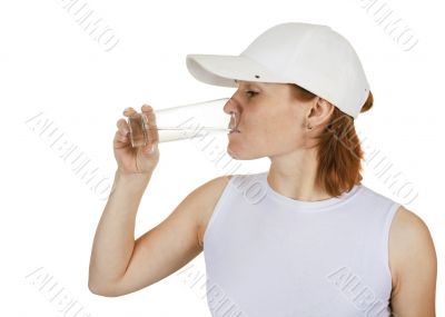 Girl in a cap and a water glass