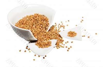 Broken white cup and buckwheat