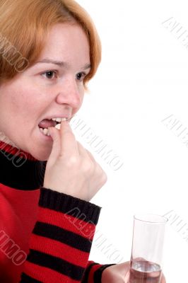 Girl with tablets and a glass