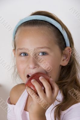 little girl eating apple
