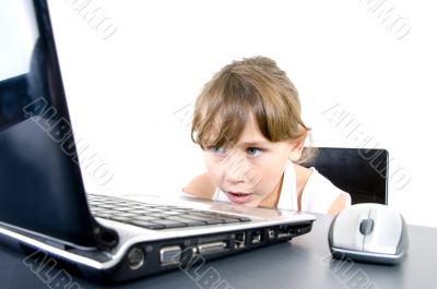 small girl looking to laptop