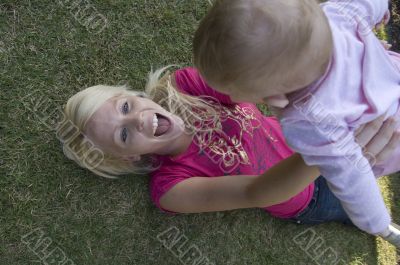 beautiful mother playing with her newborn baby
