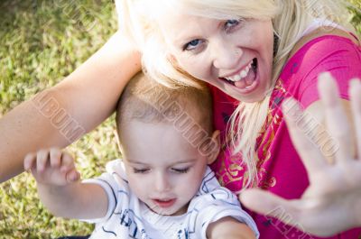 blonde young mother posing with her baby