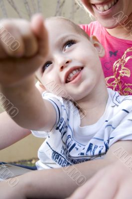 adorable young kid pointing towards camera