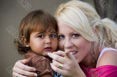 caucasian lady telling her child to look at camera