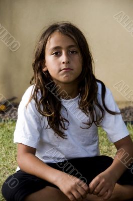  boy sitting with his legs crossed