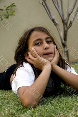 boy lying on lawn grass