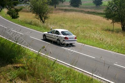 Car on the move at a country road