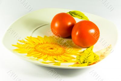 Two tomatos on plate