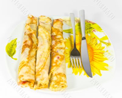 Pancakes in dish with sunflower