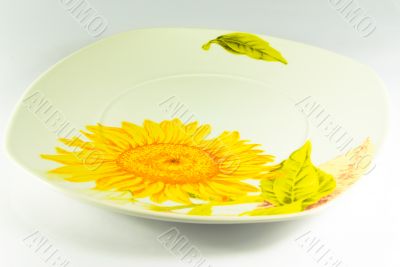 Plate with sunflower on white