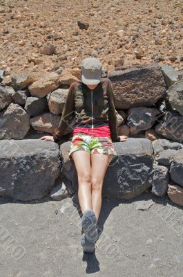 woman sitting on stone woman sitting on stone