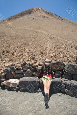 woman sitting down the volcano woman sitting down the volcano