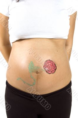 30 weeks pregnant teenager with a flower on her belly